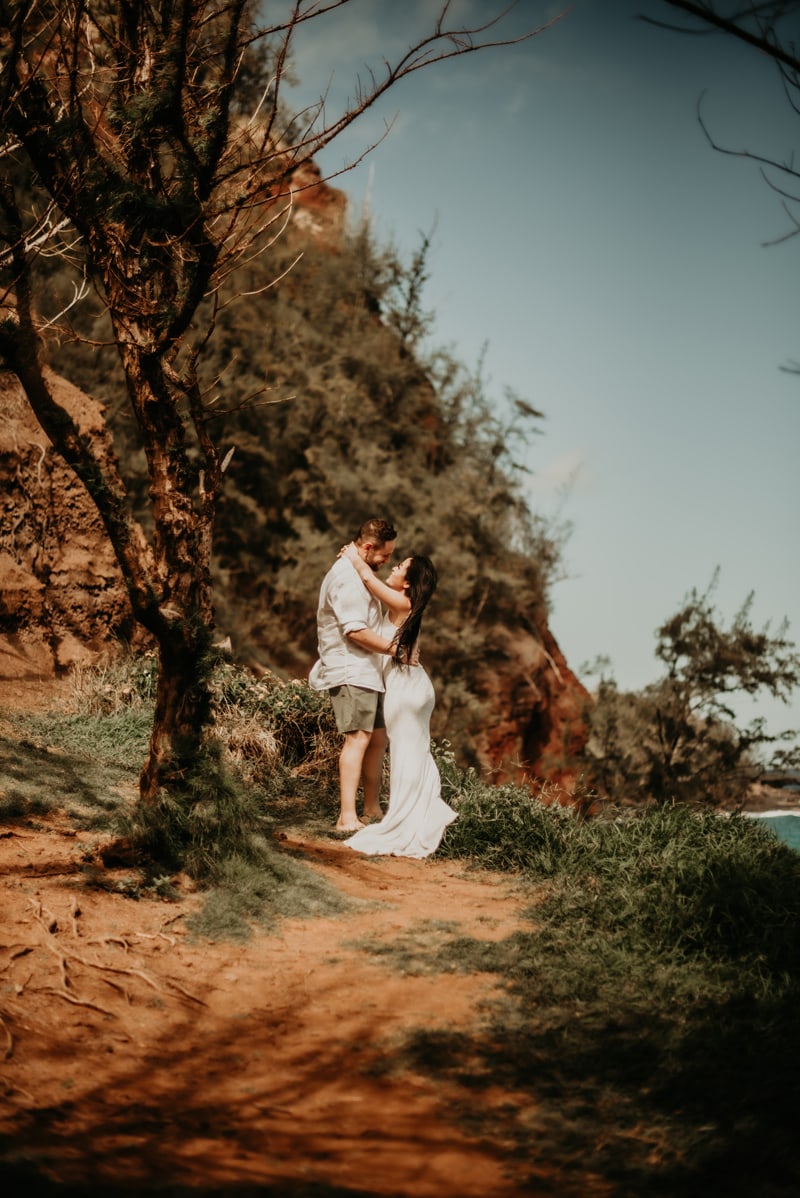 Elopement Photographer, a bride and groom on a trail beside the ocean